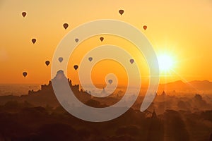 Beautiful sunrise and hot air balloons over ancient pagoda in Ba