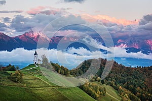 Beautiful sunrise landscape of church Jamnik in Slovenia with cloudy sky