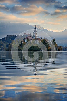 Beautiful sunrise landscape of famous mountain lake Bled in Slovenia with church on small green island