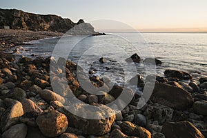 Beautiful sunrise landscape image of Church Ope Cove in Portland