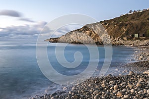 Beautiful sunrise landscape image of Church Ope Cove in Portland