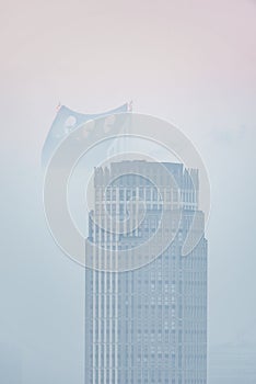 Beautiful sunrise landscape image of fog above London city landmarks with besutiful soft light on skyscrapers