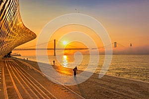 Beautiful Sunrise in Lisbon, Portugal with View of 25 de Abril Bridge