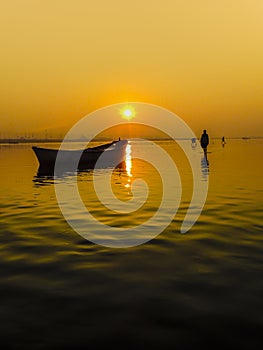 Landscape showing a beautiful sunrise on the Ganges river in the city of Allahabad, India. photo