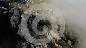 Beautiful sunrise with mountain scenery and low clouds. Shot. Spectacular flight over clouds at rocky mountain slopes at