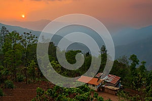 Beautiful sunrise in mountains of Himalayas, Hee Barmiok village of Sikkim, India. Wooden houses in the middle of scenic view of