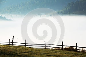 Beautiful sunrise in mountains with white fog.Travel background. Exploring beauty world. Carpathian mountains. Ukraine. Europe. Su