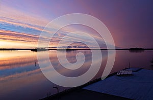 Beautiful sunrise over calm water by the dock in Sweden