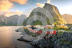 Beautiful sunrise over Hamnoy, fishermen village with the typical red houses of the Lofoten Islands , Norway