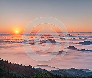 A beautiful sunrise over a mountain range with clouds in the foreground.