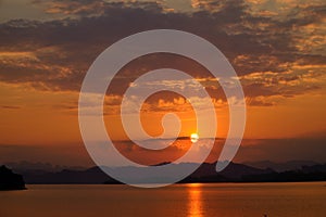 Beautiful sunrise over mountain range view from wooden terrace