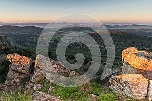 Beautiful sunrise over mountains and hills covered with greenery in Spain