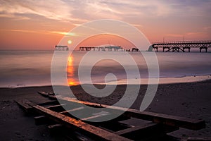 Beautiful sunrise over the old broken bridge. Low light long exposure.