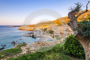 Beautiful Sunrise over Pebble Beach and Cliffs at Rhodes Island, Greece