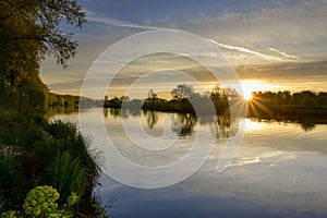 Beautiful sunrise reflecting in the river ath kortrijk belgium