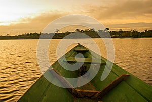 Beautiful sunrise on the river. View from the boat at Amazon river, with a dense forest on the shore and blue sky, Anazonas,