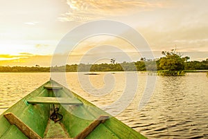 Beautiful sunrise on the river. View from the boat at Amazon river, with a dense forest on the shore and blue sky, Anazonas,