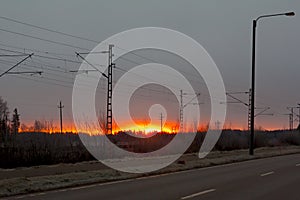 Beautiful sunrise at road and railroad at autumn in Finland