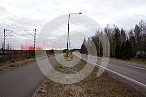 Beautiful sunrise at road and railroad at autumn in Finland