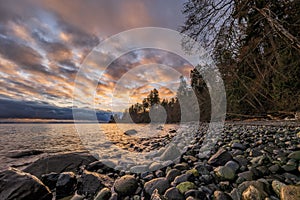 Beautiful sunrise on rocky beach.