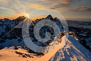 Beautiful sunrise from Rysy peak during winter golden hour photo