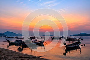 Beautiful sunrise scenery with fishing boats at Rawai Beach in Phuket Island, Thailand
