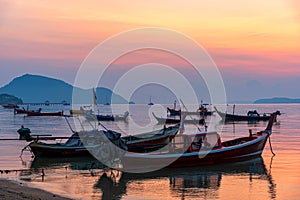 Beautiful sunrise scenery with fishing boats at Rawai Beach in Phuket Island, Thailand