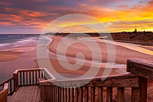 A beautiful sunrise at southport port noarlunga south australia overlooking the wooden staircase ocean and cliffs on the 30th