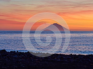 Beautiful sunrise withe the Stromboli island seen from the Salina island in the Aeolian islands, Sicily, Italy photo