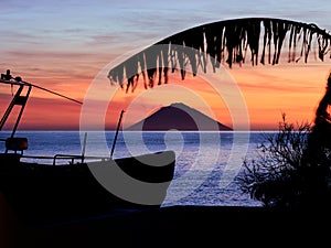 Beautiful sunrise withe the Stromboli volcano seen from the Salina island in the Aeolian islands, Sicily, Italy