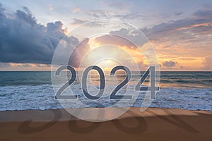 Beautiful sunset with 2024 and shadow on beach. New year, 2024 Goals concept. Free space for text