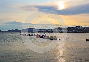 Beautiful sunset on Aegean coast with islands and mountains, boats and catamarans