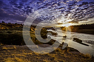 Sunset along Missouri river along dam photo