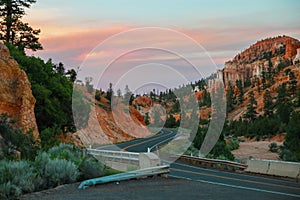 Beautiful sunset at the background. The road is leading to the Bryce Canyon National Park in Utah, USA