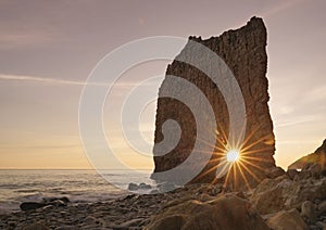 Beautiful Sunset on Beach. Catch the Sun Trough the Hole