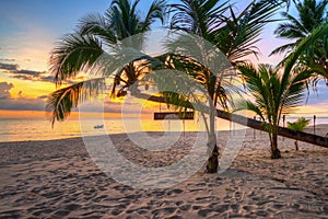 Beautiful sunset on the beach of Ko Kho Khao island with palm trees, Thailand