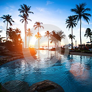 Beautiful sunset at a beach resort in tropics. Travel.