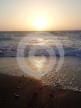 Beautiful sunset on the beach on the waterfront.