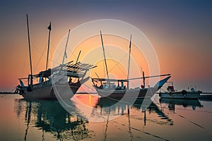 Beautiful Sunset Boats in seaside with red and dark sky. Dammam -Saudi Arabia photo