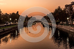 Beautiful sunset Bucharest Romania Bucuresti Dambovita river landscape reflection photo