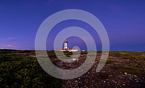 Beautiful sunset of cape Espichel and working lighthouse, Portugal