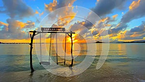 Beautiful sunset on the coast of Hainan China swing beach sea sky clouds