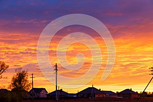 Beautiful sunset. Colorful dramatic sky at sunset. Layered rain clouds. Bright blue orange background. The texture of the sunset.