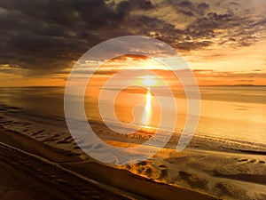 Beautiful sunset colors over the coastline of Allerdale district in Cumbria, UK. Sun setting over the shore of Allonby bay on