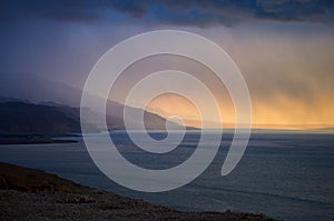 Beautiful sunset at Dead Sea, Jordan. Salt beach. Rays of lights