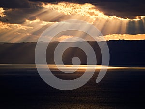 Beautiful sunset at Dead Sea, Jordan. Salt beach. Rays of lights