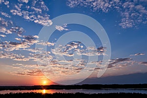 Beautiful sunset with dramatic clouds over a lake