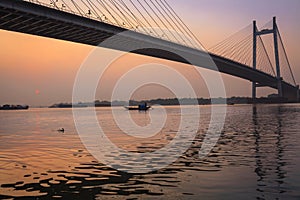 Beautiful sunset hue on river Hooghly with the Vidyasagar Setu bridge at the backdrop.