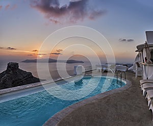 Beautiful sunset at infinity pool in Santorini