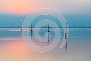 Beautiful sunset in the lagoon of Venice with calm water in the industrial area of Porto Marghera